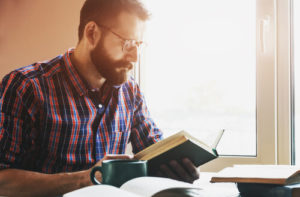 Man reading book during addiction recovery