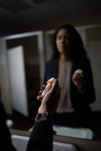 woman struggling with pills